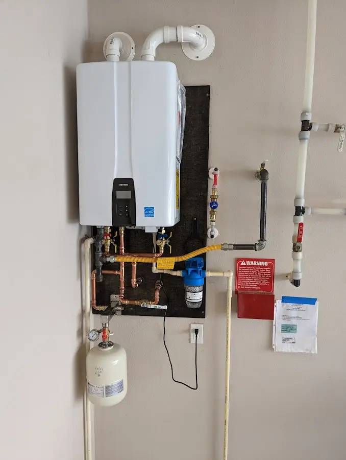 Professional plumber installing copper piping in a Mesa home